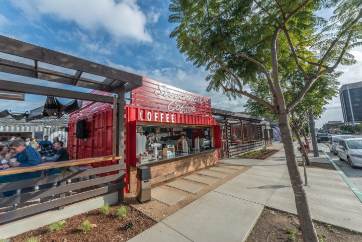 An exterior shot of SteelCraft Long Beach featuring the Steelhead Coffee container open to the sidewalk.
